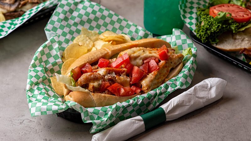 Urie's Kicken Chicken sandwich with a side of potato chips