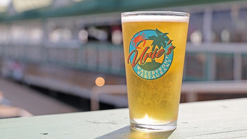 Pint of beer in a pint glass with the Urie's logo