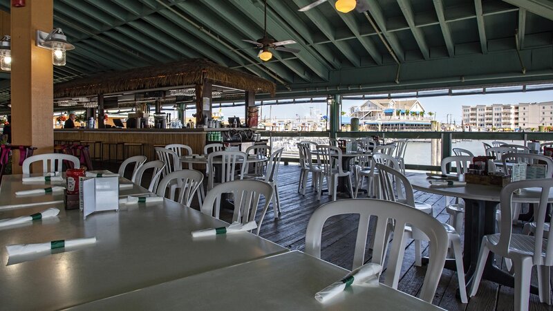 Outdoor patio dining area with view of outdoor bar